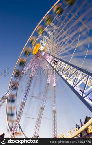 Big wheel on a fun fair with colorful lights. Motion blurred. Long exposure time with tripod.