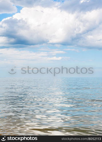 big white cloud over calm water of Azov Sea, Temryuk bay, Golubitskaya resort, Taman peninsula, Kuban, Russia