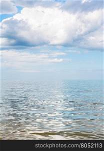 big white cloud over calm water of Azov Sea, Temryuk bay, Golubitskaya resort, Taman peninsula, Kuban, Russia