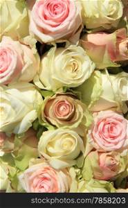 Big wihite and pink roses in a pastel wedding arrangement