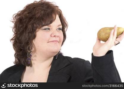 Big woman holding up a pear