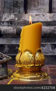 Big yellow candle in buddhist temple, Thailand