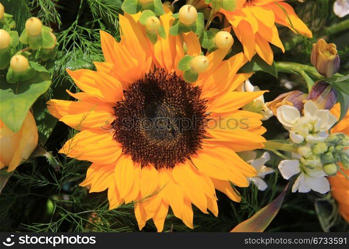 Big yellow sunflower in a floral composition