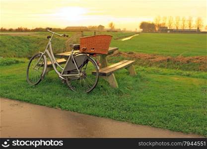 Bike against a picnic bench in the countryside from the Netherlands at twilight