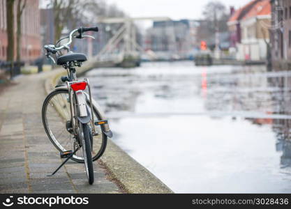 Bike by a canal in Gouda. Bike by a canal in Gouda - Netherlands