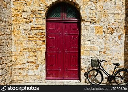 Bike near the Solid Wooden Door in the French City