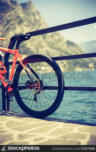 Bike on the foreground, lake garda with blue water in the background