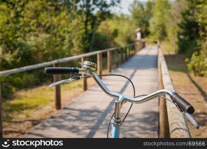 Bike path and bicycle handlebar close-up. Bicycle friendly city. Eco-friendly transport and healthy lifestyle concept.