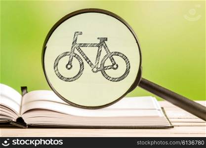 Bike search with a pencil drawing of bicycle in a magnifying glass
