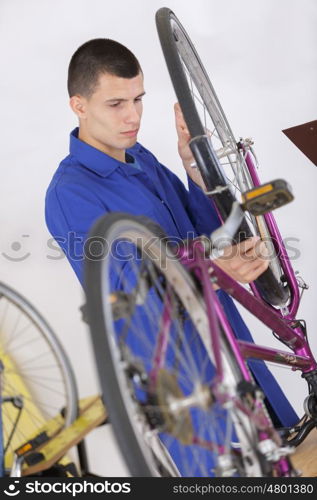 bike service mechanic serviceman repairman a bicycle tyre