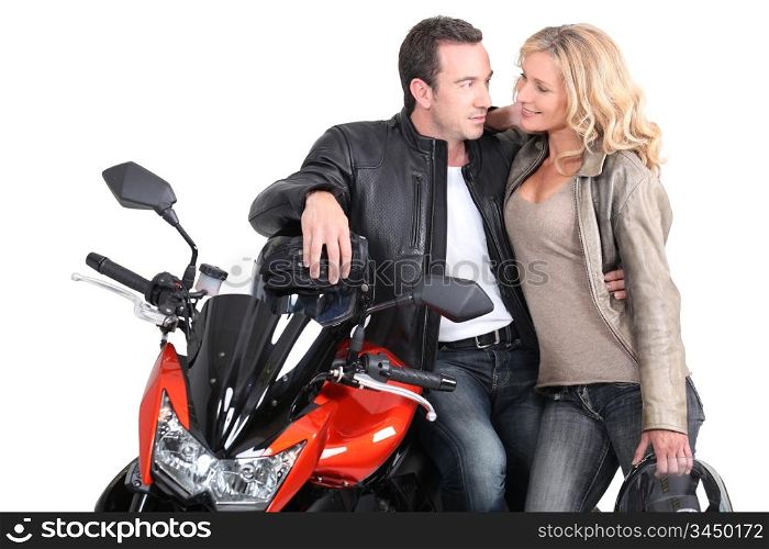 Biker couple gazing into each other&rsquo;s eyes.