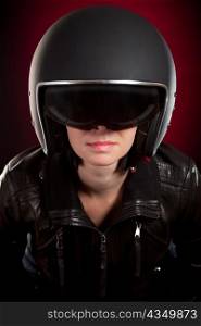 Biker girl in a helmet on a red background