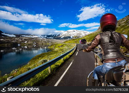 Biker girl rides a mountain road in Norway. First-person view.