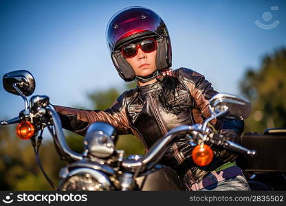 Biker girl sits on a motorcycle