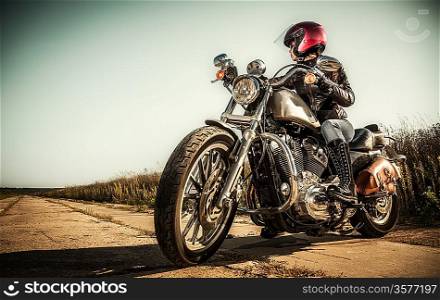 Biker girl sits on a motorcycle