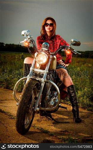 Biker girl with sunglasses and motorcycle