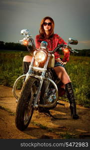 Biker girl with sunglasses and motorcycle