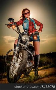 Biker girl with sunglasses and motorcycle