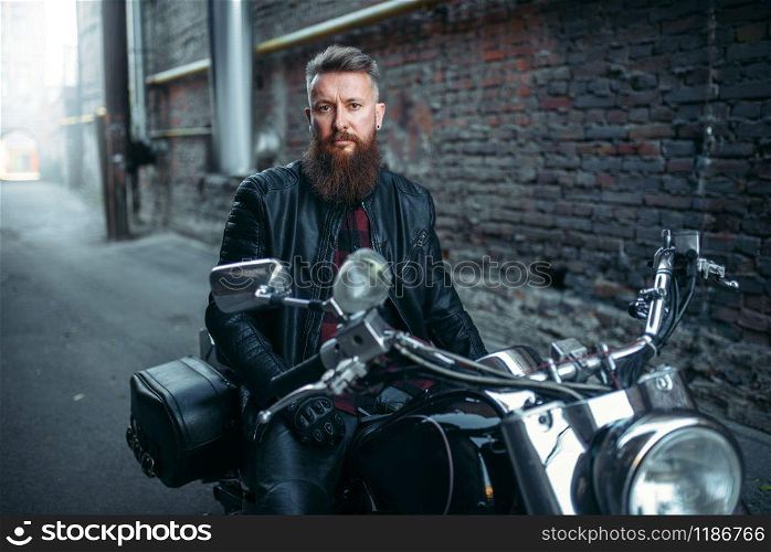 Biker in leather jacket sitting on classical chopper. Vintage bike, rider on motorcycle, two-wheeled transport