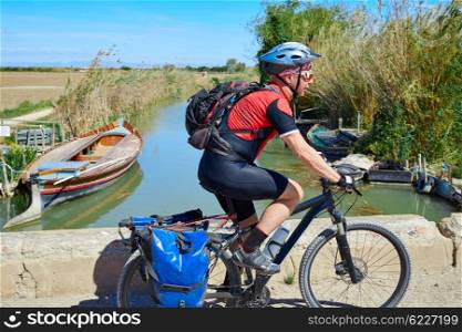 Biker MTB cycle tourism with panniers in Albufera of valencia spain