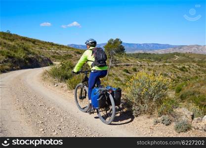 Biker MTB cycle tourism with panniers in Turia Park at pedralba of valencia