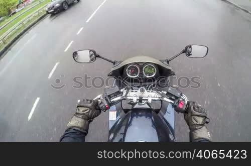 Biker rides on the road in the city - time lapse