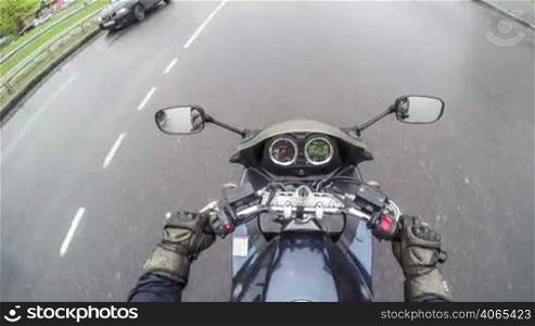 Biker rides on the road in the city - time lapse