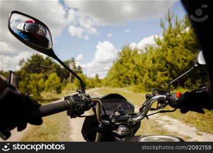 biker riding motorbike dirt road