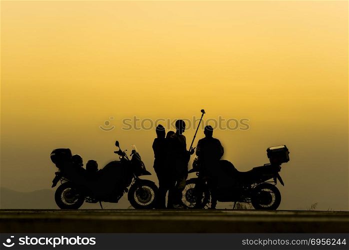 Biker tourists enjoy take a photo at sunset.