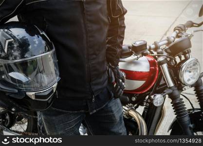 Biker wear jacket suit hold helmet with retro motorcycle