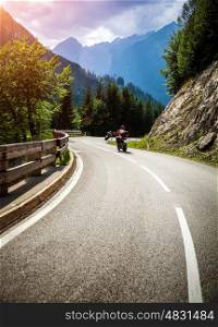 Bikers on mountainous race, curve road in Alpine mountains, Austria, Europe, extreme touring, happy lifestyle, travel and journey concept