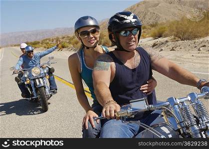 Bikers riding on desert road