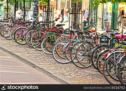 Bikes parked in the city, in a nice line into a rack
