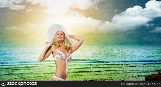 Bikini girl. Beautiful blond girl in hat and white swimsuit bikini