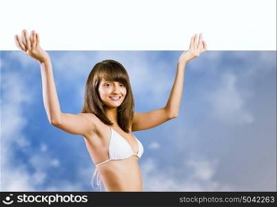 Bikini girl presenting something. Attractive girl in bikini with white blank banner