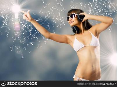 Bikini girl wearing headphones. Young attractive girl in white bikini touching icon