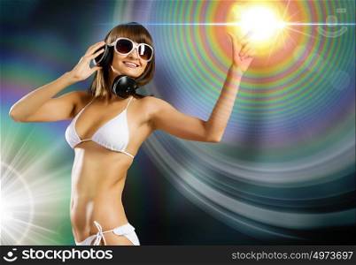Bikini girl wearing headphones. Young attractive girl in white bikini touching icon