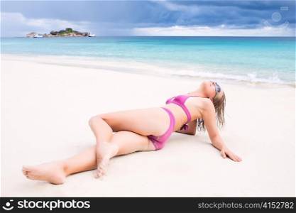 Bikini sexy girl laying on the beach