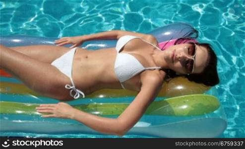 Bikini Woman on Air Bed In Swimming Pool