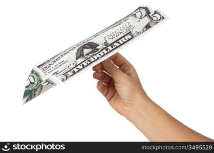 bill of five dollars turned a paper airplane a over white background
