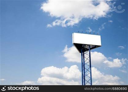 Billboard over blue cloudy sky