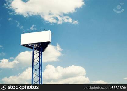 Billboard over blue cloudy sky