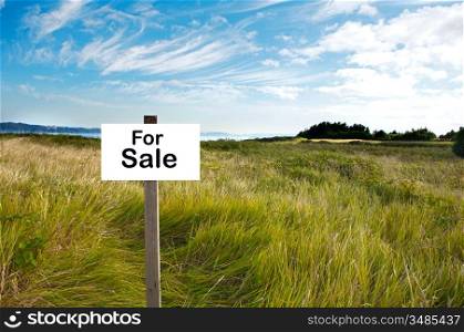Billboard with the word For Sale in a beautiful landscape