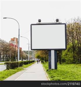 billboard with two lamp near sidewalk city