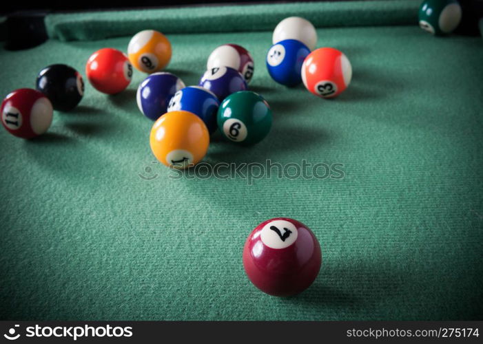 billiard table with green material and billiard balls