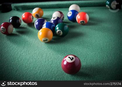 billiard table with green material and billiard balls
