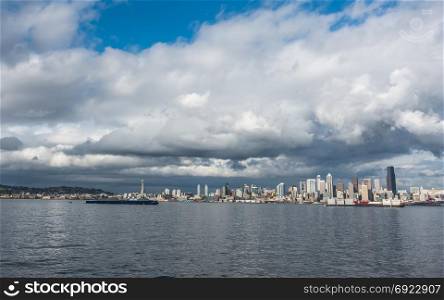 Billowing clouds hover over the Seattle skyline.