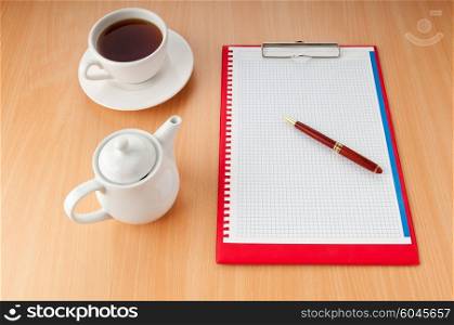Binder with blank page and tea
