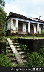 BINH DINH, VIET NAM- NOV 2, 2017: Desert house downgrade with wood door, stairs in front of, the old home with traditional architecture begin corrupt by time