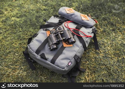 binoculars backpack grass